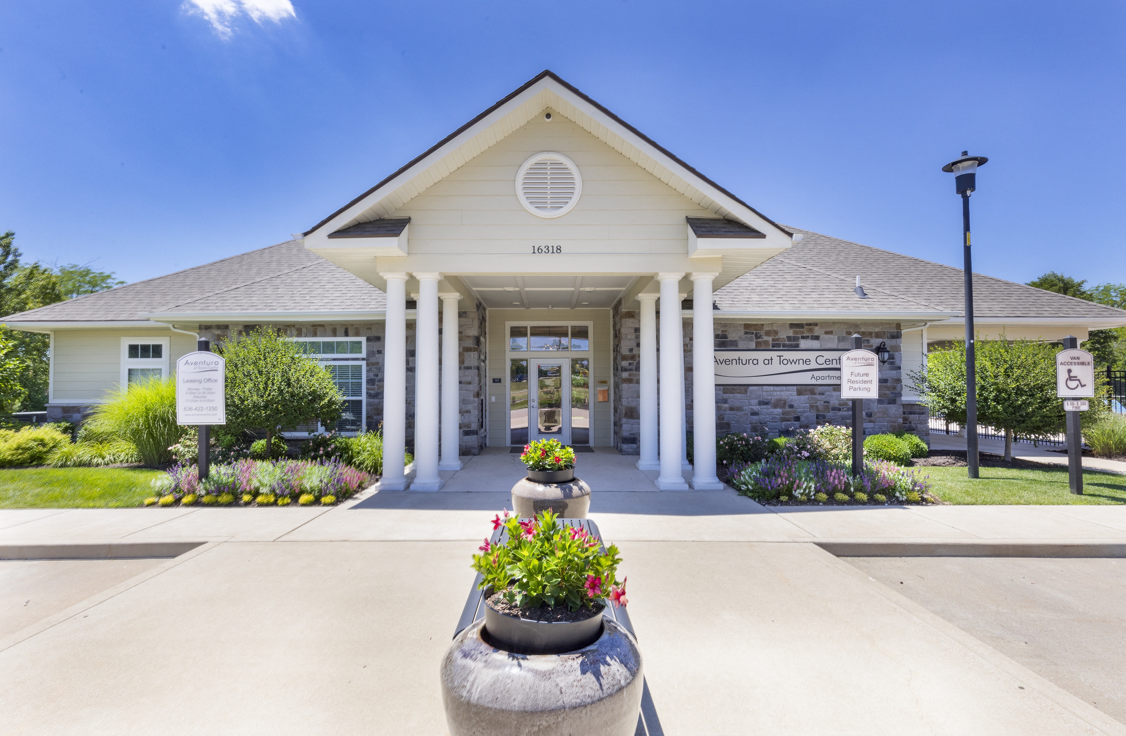 the front of a building with flowers in front of it at Aventura at Towne Centre, Missouri